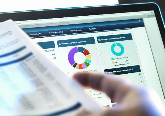 laptop with reporting documents 